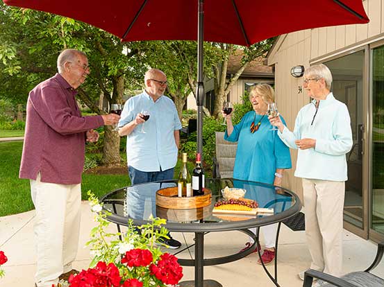 Residents enjoying time on the patio at Foxdale Village